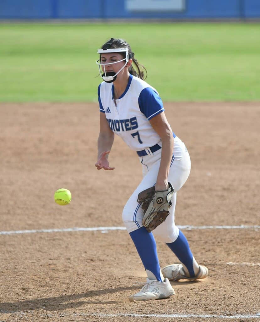 Female softball player in action for Madera Coyotes during game.