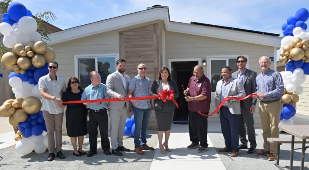 Group of people at ribbon-cutting ceremony for new tiny homes at Madera Rescue Mission.
