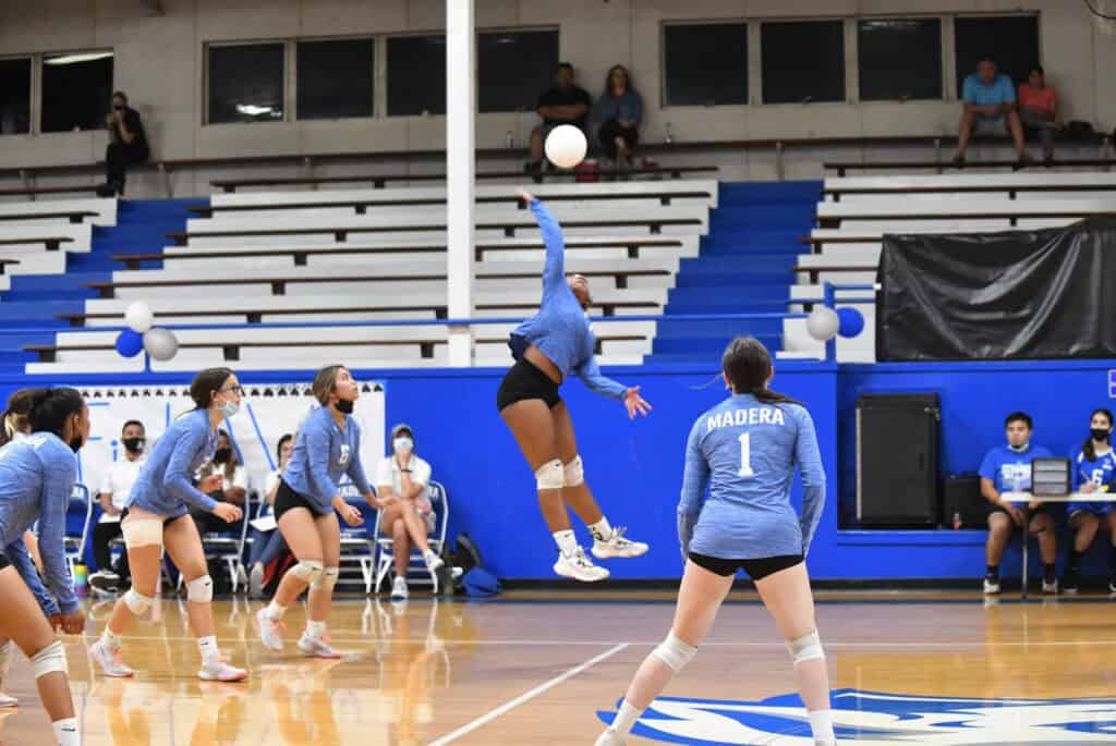Madera volleyball players in action during a match against Edison.