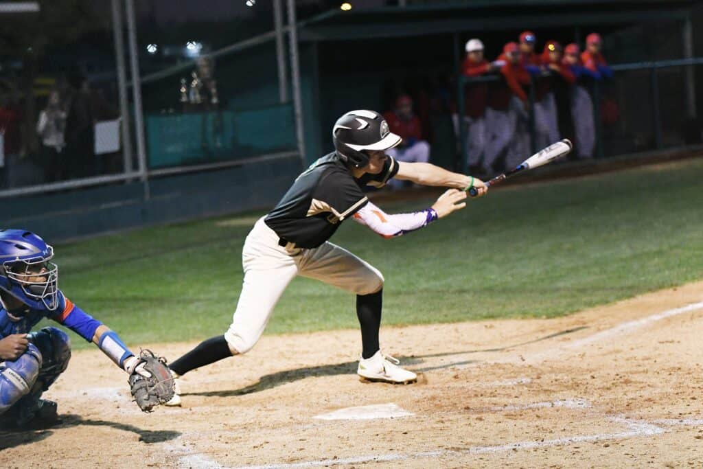 Hawks baseball player swinging at a pitch during Fowler Easter Classic.