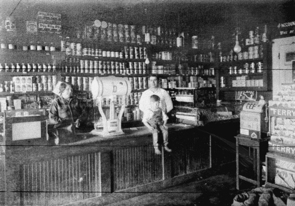 Vintage Madera store interior with shelves stocked with bottles and goods from early 20th century.