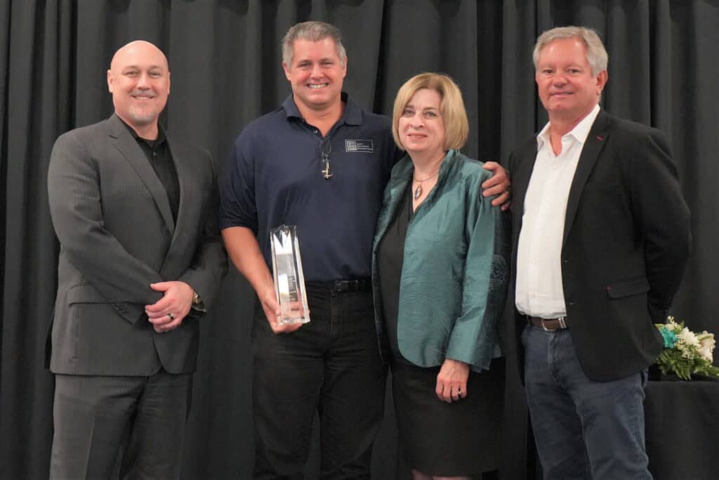 Local business receiving Crystal Tower Award at Madera event.