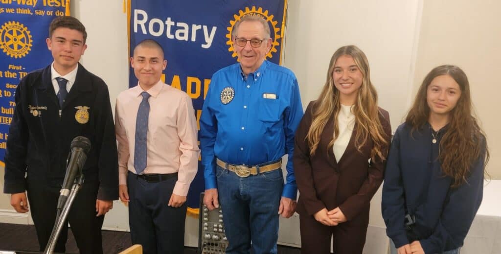 Madera County Rotary Club awards speech winner with students and club president.