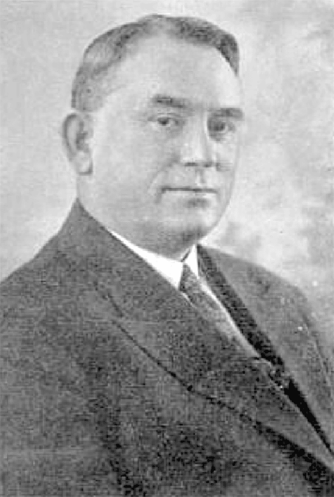 Black and white portrait of a man in a suit from the Madera Tribune archives.