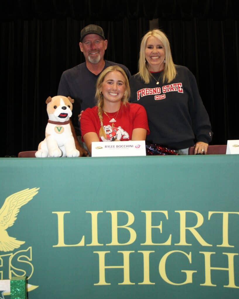 Liberty record breaker with family at Madera High School event.