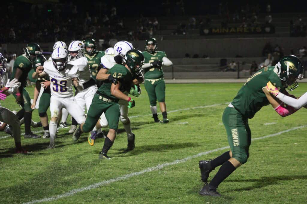 Madera Mustangs football team scores against undefeated rivals in a thrilling game.