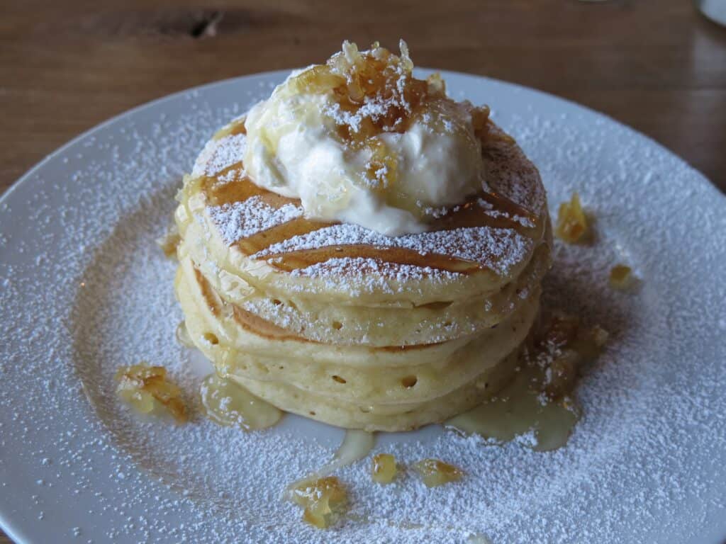 Scrambled pancakes topped with whipped cream and caramel, perfect for celebrating moms.